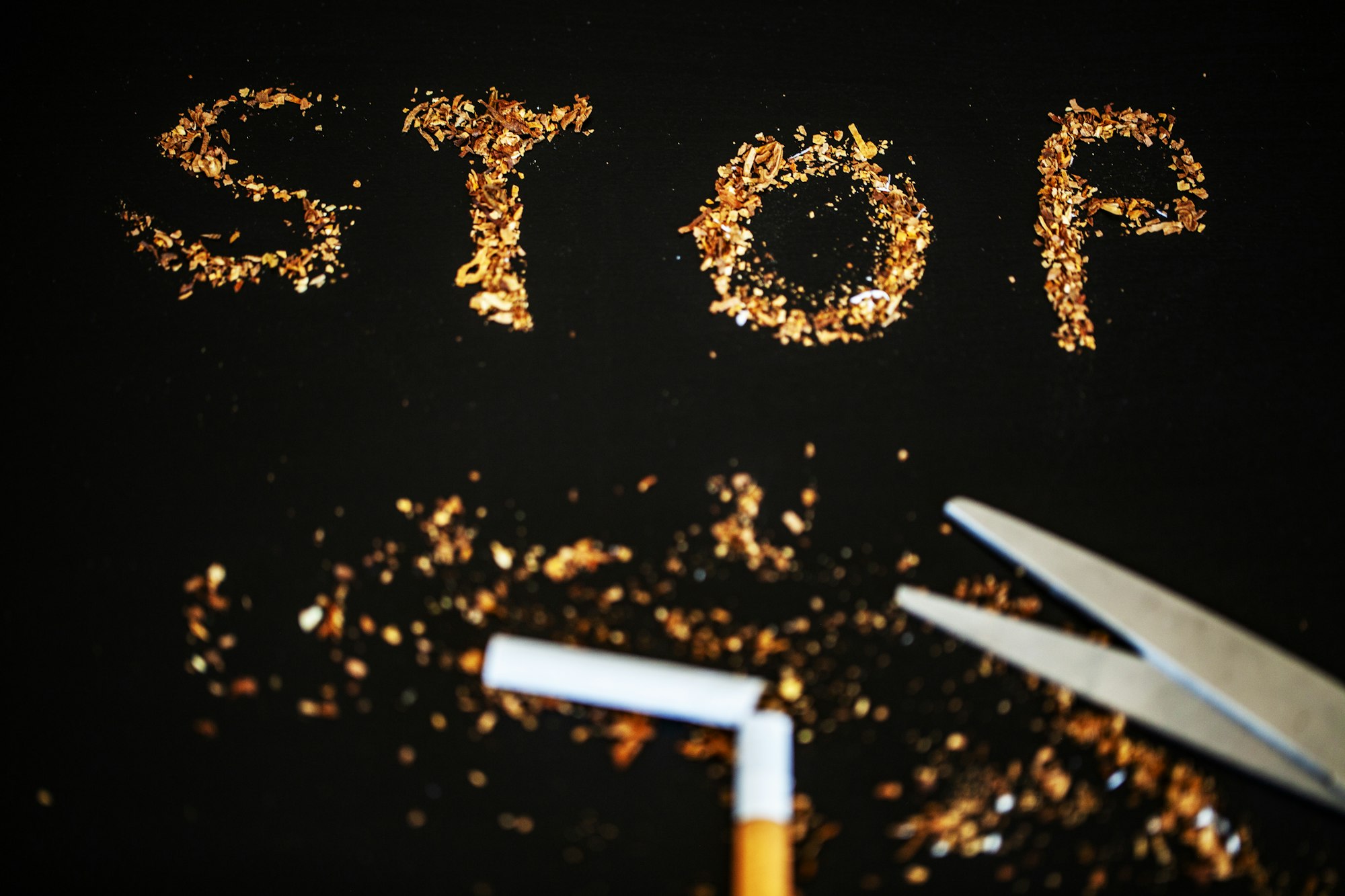 Stop smoking concept on background with broken cigarettes. Heap of cigarettes. No smoking